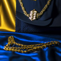 Pictures of rapper in gold and navy blue with chains 